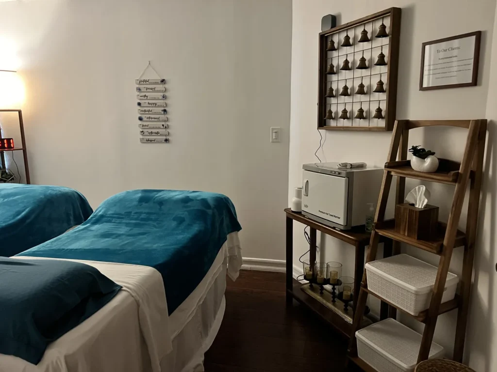 Couples room with two tables and a shelf holding treatment supplies