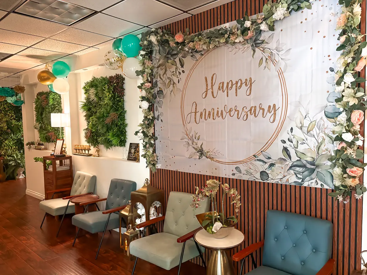 Anniversary backdrop and floral arch set up in the lobby seating area